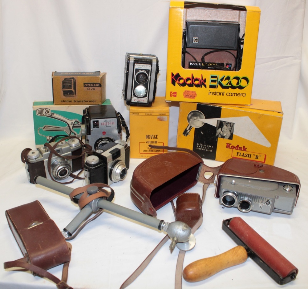 A selection of various Kodak cameras together with accessories, boxed flash light,