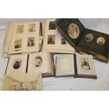 A Victorian family photograph album with decorated pages containing a selection of over 45 various