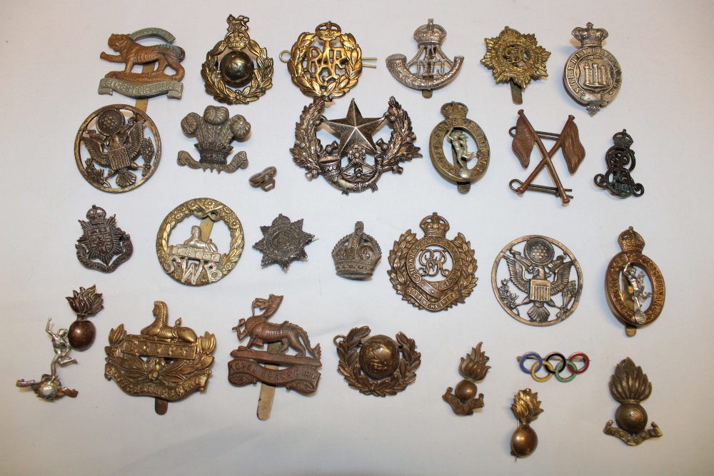 A selection of various military cap badges including the Northumberland Volunteers, Cameronians,