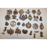 A selection of various military cap badges including the Northumberland Volunteers, Cameronians,