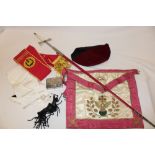 A Masonic sword with plain double edged blade in red scabbard, various aprons, sashes etc.