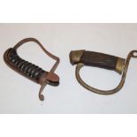 A steel stirrup hilt from a 1796 pattern cavalry sword with ribbed wooden grip and one other brass