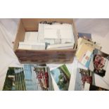 A box containing various modern postcards, PHQ cards,