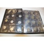 A folder album containing a collection of over 100 various silver 3d coins,