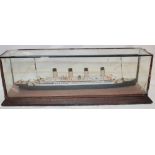 A small old wooden model liner in glazed display case,