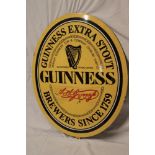 A modern enamel oval advertising sign "Guinness",
