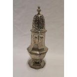 A silvered hexagonal baluster-shaped sugar sifter with pierced domed top,