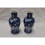 A pair of 19th century Chinese baluster-shaped vases with blossom decoration on blue ground, signed,