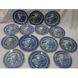 Fourteen various 18th and 19th century pottery circular plates with blue and white 'Willow' pattern