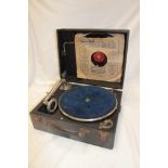 An old portable gramophone with chromium plated mounts in black fibre case