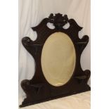 A late Victorian/Edwardian carved mahogany over mantel mirror with bevelled central panel flanked