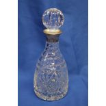 A good quality cut glass tapered decanter and stopper with silver mounted neck,