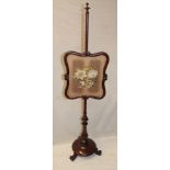 A Victorian rosewood pole screen with a tapestry floral panel on turned column with circular base