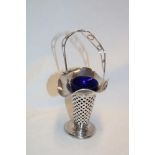 A silver tapered posy vase with loop handle and blue glass liner,
