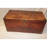 An old brass mounted teak rectangular trunk with hinged lid and brass handles,