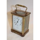 A good quality carriage clock by D Munsey of Cambridge with enamelled rectangular dial in brass