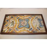 A frame containing 8 early ceramic tiles,