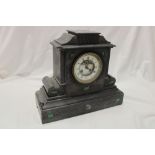 A Victorian mantel clock with enamelled circular part visible escapement in black slate traditional