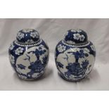 A pair of 19th century Chinese circular ginger jars and covers with blue and white decoration,