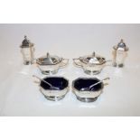 A George V silver six-piece cruet set comprising a pair of rectangular tapered pepperettes,