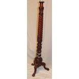 A good quality carved mahogany standard lamp with spiral turned column and carved tripod base