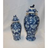 A 19th century Chinese baluster-shaped vase and cover with blue and white blossom decoration,