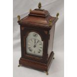 A good quality German bracket clock with silvered arched dial in inlaid mahogany tapered case with