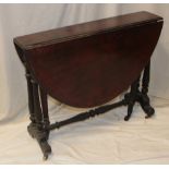 A Victorian walnut oval Sutherland-style tea table on turned tapered legs with casters