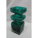 A green tinted art glass square vase with raised roundel design,