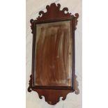 A 19th century rectangular wall mirror in mahogany scroll frame,