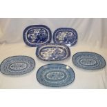 Three 19th century pottery oval platters with blue and white floral decoration,