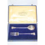 An Indian silver anointing-style spoon and fork with elephant decorated handles in velvet lined
