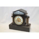 A Victorian mantel clock with decorated circular dial in brass mounted black slate pavillion-style