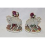 A pair of Staffordshire pottery rustic spill vases with encrusted sheep decoration on oval bases,