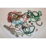 A selection of various costume jewellery including bead necklaces, bangles, brooches,