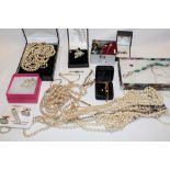 A selection of various costume jewellery including necklaces, brooches,