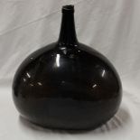 A large old glass squat-shaped bottle,