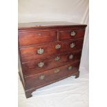 A George III mahogany chest of two short and three long drawers with brass ring handles on bracket