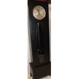A 1930s Art Deco ebonised grandfather-style clock by Enfield with silvered circular dial and