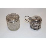 A silver cylindrical mustard pot with pierced decoration and blue glass liner,