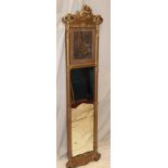 An old rectangular wall mirror in ornate gilt relief decorated frame inset with a black and white