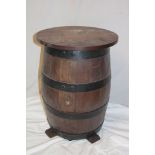 An old barrel table with polished circular top,