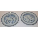 A pair of 18th century Chinese circular plates with blue and white animal and landscape decoration,