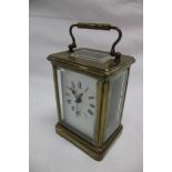 A French carriage clock with enamelled rectangular dial in brass traditional glazed case