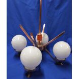 An Art Deco-style copper four branch ceiling light with coral bakelite centre and four opaque glass