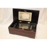 A 19th century music box with ebonised interior, 6-tune card in simulated rosewood rectangular case,