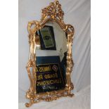 A good quality 20th century arched wall mirror in ornate gilt decorated scroll frame,