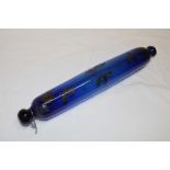 A 19th century Bristol blue tinted glass rolling pin with painted floral decoration,