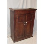 A 19th century oak rectangular wall cupboard with shelves enclosed by two panelled doors,