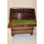 A small 19th century mahogany bureau with pigeon holes and drawers enclosed by a fall front above